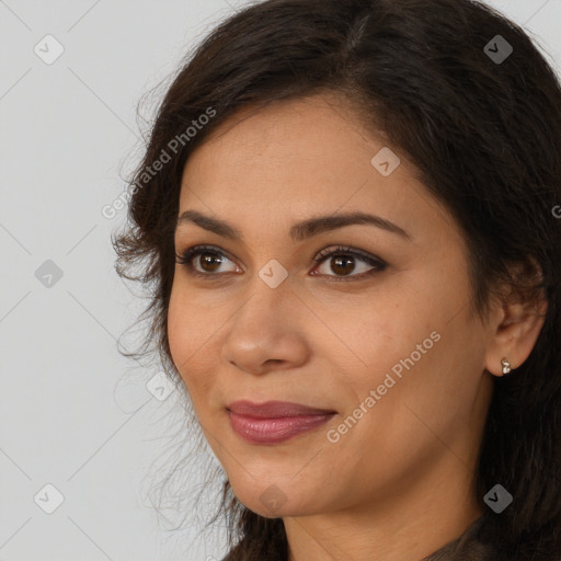 Joyful latino young-adult female with long  brown hair and brown eyes