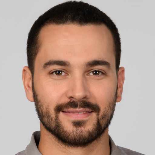 Joyful white young-adult male with short  brown hair and brown eyes