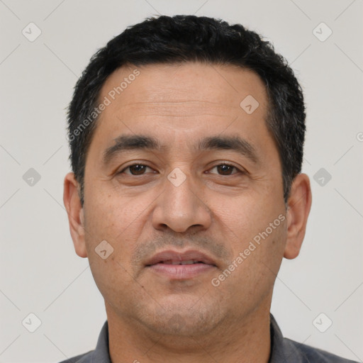 Neutral latino adult male with short  black hair and brown eyes