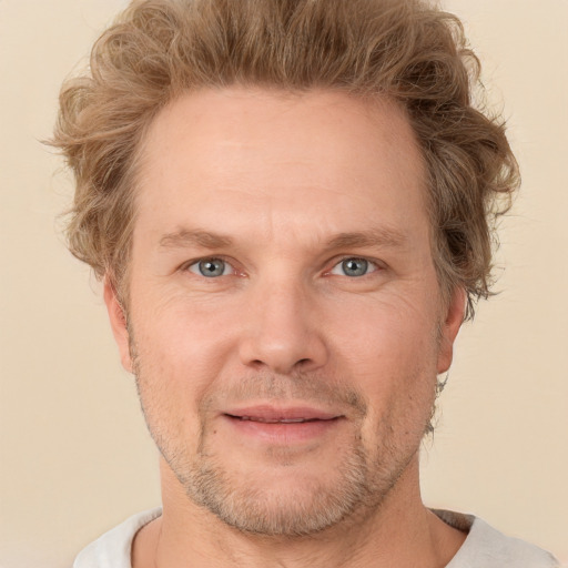 Joyful white adult male with short  brown hair and grey eyes