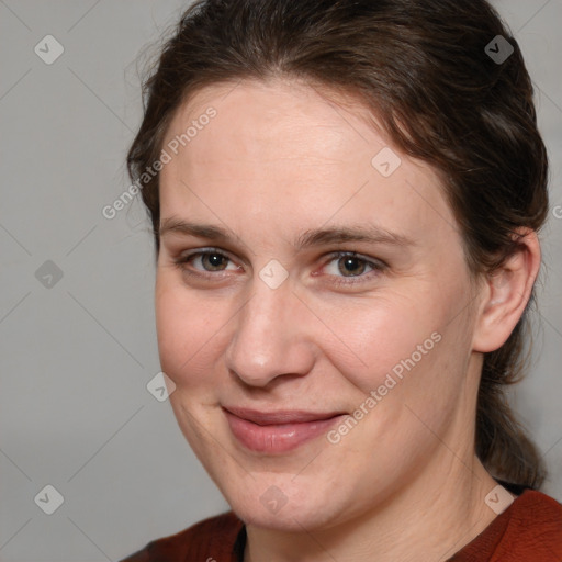 Joyful white adult female with medium  brown hair and brown eyes