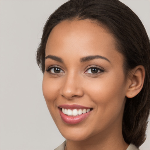 Joyful white young-adult female with long  brown hair and brown eyes