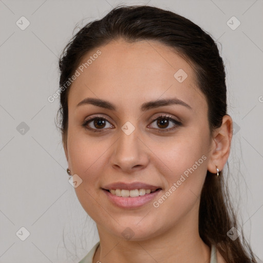 Joyful white young-adult female with long  brown hair and brown eyes