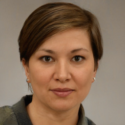 Joyful white adult female with medium  brown hair and brown eyes