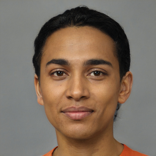 Joyful latino young-adult male with short  black hair and brown eyes