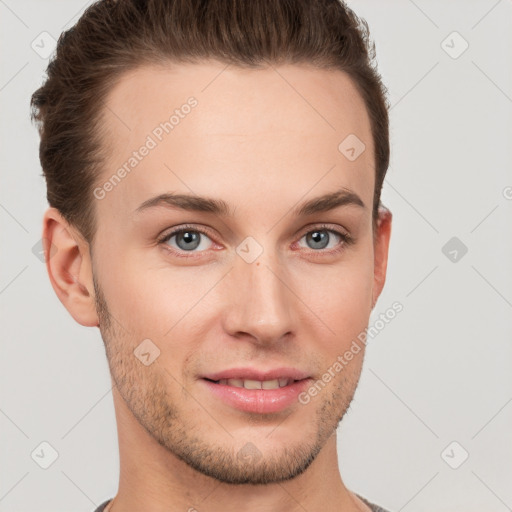 Joyful white young-adult male with short  brown hair and grey eyes