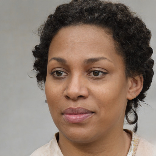 Joyful black young-adult female with medium  brown hair and brown eyes