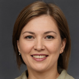 Joyful white adult female with medium  brown hair and brown eyes