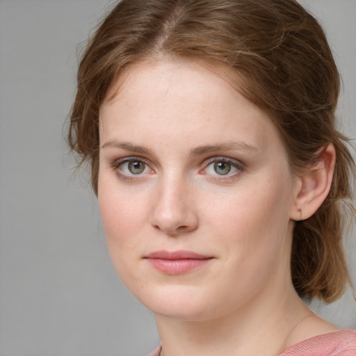 Joyful white young-adult female with medium  brown hair and blue eyes