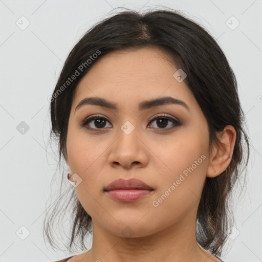 Joyful latino young-adult female with medium  brown hair and brown eyes