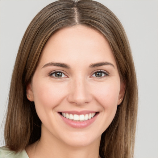 Joyful white young-adult female with long  brown hair and green eyes