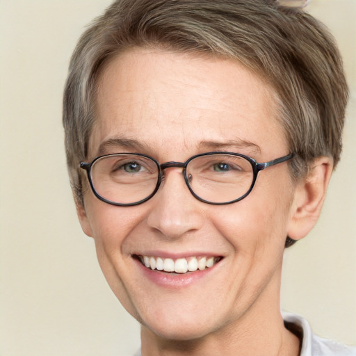 Joyful white adult female with short  brown hair and green eyes