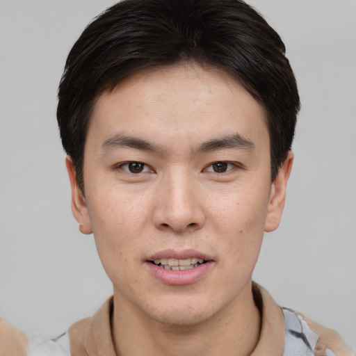 Joyful asian young-adult male with short  brown hair and brown eyes