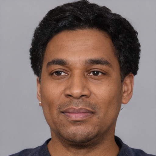 Neutral latino adult male with short  black hair and brown eyes