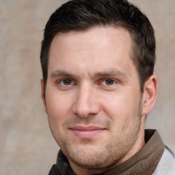 Joyful white adult male with short  brown hair and brown eyes