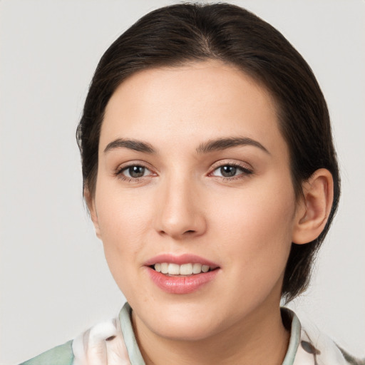 Joyful white young-adult female with medium  brown hair and brown eyes