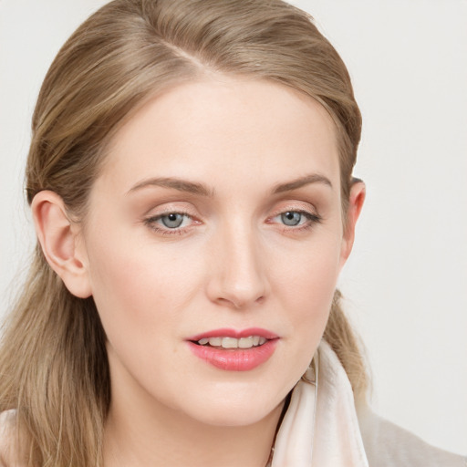 Joyful white young-adult female with long  brown hair and blue eyes