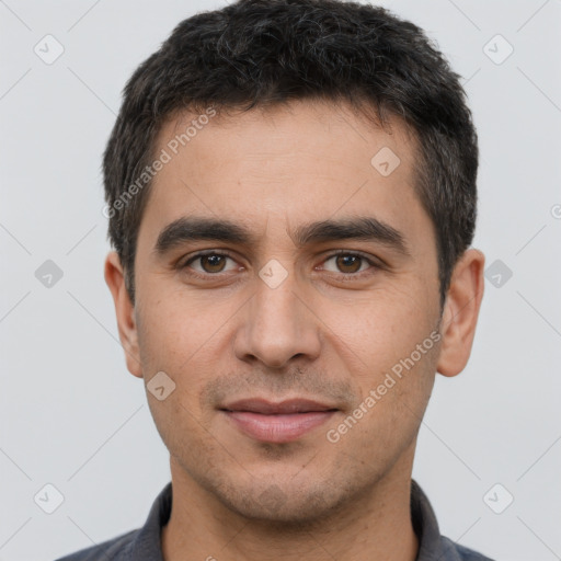 Joyful white young-adult male with short  black hair and brown eyes