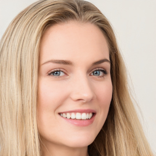 Joyful white young-adult female with long  brown hair and green eyes