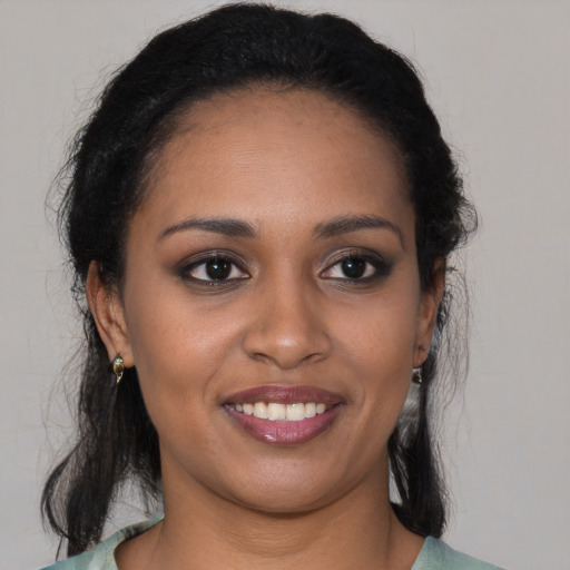 Joyful black young-adult female with medium  brown hair and brown eyes