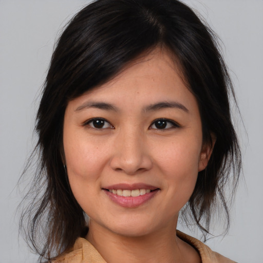 Joyful asian young-adult female with medium  brown hair and brown eyes