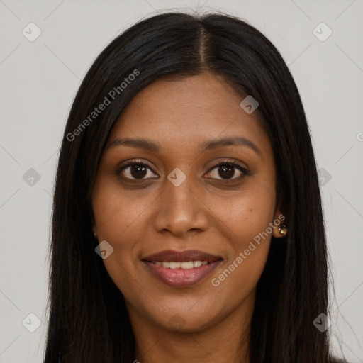 Joyful black young-adult female with long  brown hair and brown eyes