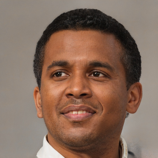 Neutral black adult male with short  black hair and brown eyes