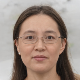 Joyful white adult female with long  brown hair and brown eyes