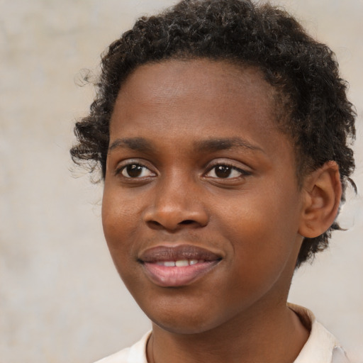 Joyful black young-adult male with short  brown hair and brown eyes