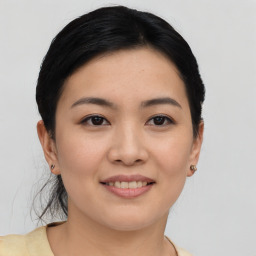 Joyful asian young-adult female with short  black hair and brown eyes