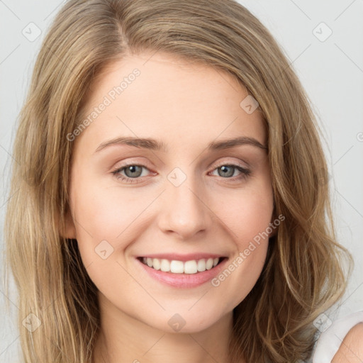 Joyful white young-adult female with long  brown hair and green eyes