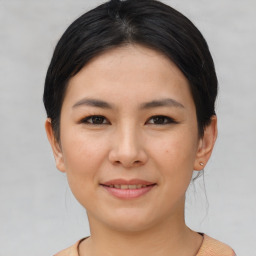 Joyful asian young-adult female with short  brown hair and brown eyes