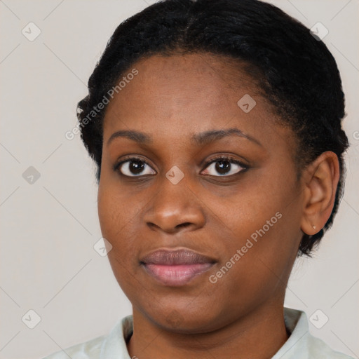 Joyful black young-adult female with short  black hair and brown eyes