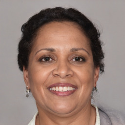 Joyful latino adult female with short  brown hair and brown eyes