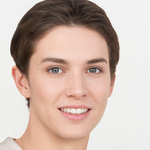 Joyful white young-adult female with short  brown hair and grey eyes