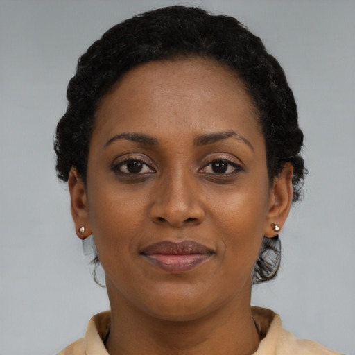 Joyful black young-adult female with short  brown hair and brown eyes