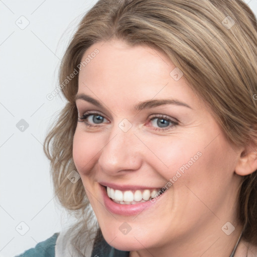 Joyful white young-adult female with medium  brown hair and blue eyes