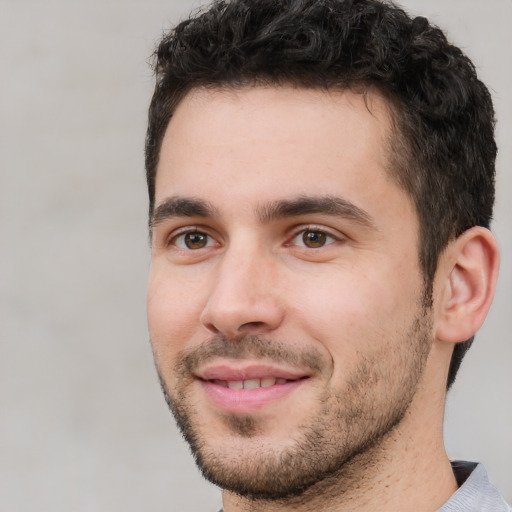 Joyful white young-adult male with short  black hair and brown eyes