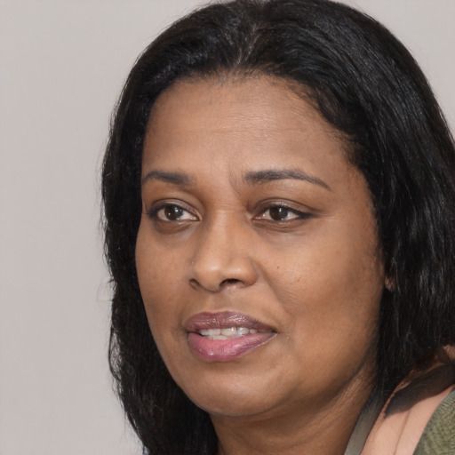 Joyful black adult female with long  black hair and brown eyes