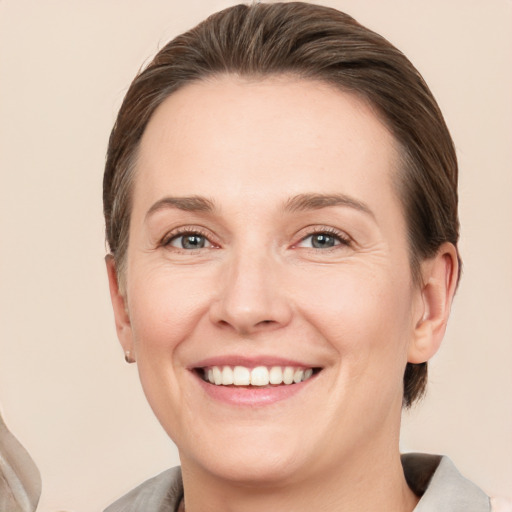 Joyful white adult female with short  brown hair and grey eyes