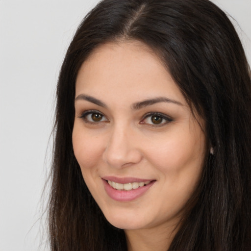 Joyful white young-adult female with long  brown hair and brown eyes