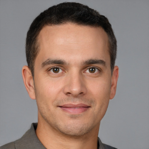 Joyful white young-adult male with short  brown hair and brown eyes