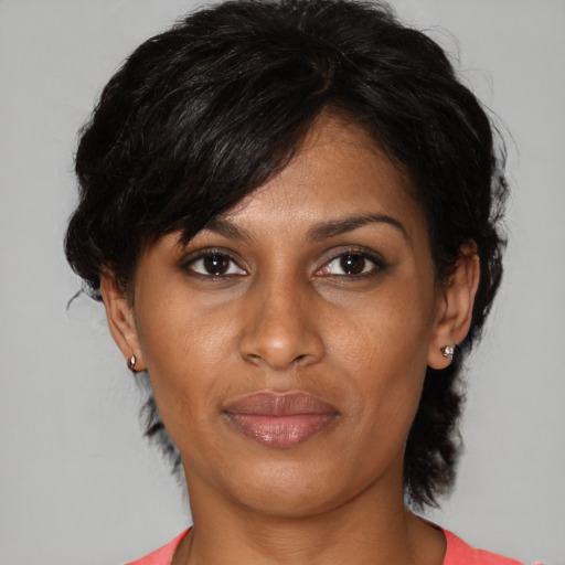 Joyful black adult female with medium  brown hair and brown eyes