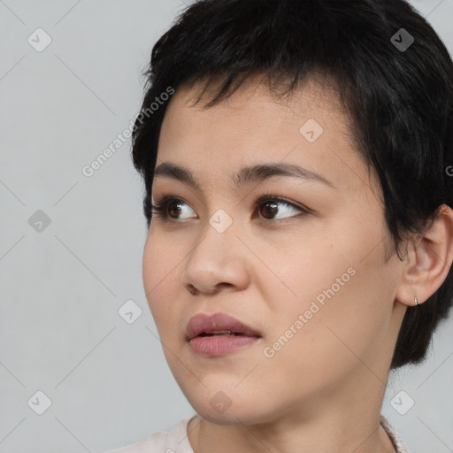 Joyful asian young-adult female with short  black hair and brown eyes