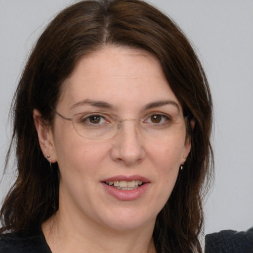 Joyful white adult female with medium  brown hair and brown eyes