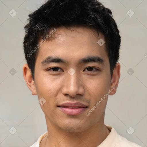 Joyful asian young-adult male with short  black hair and brown eyes