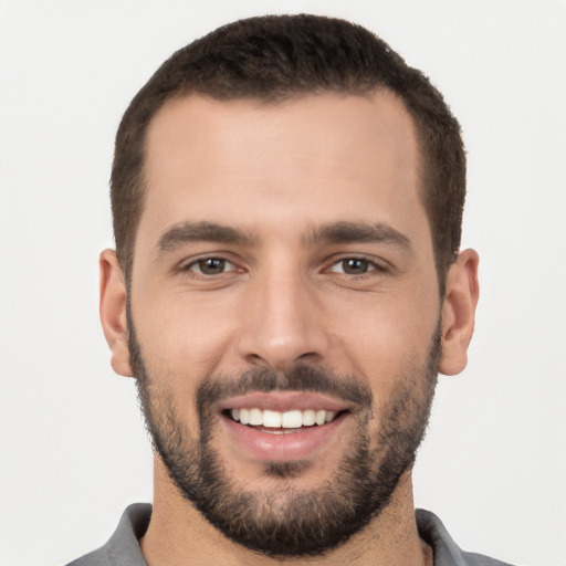 Joyful white young-adult male with short  brown hair and brown eyes