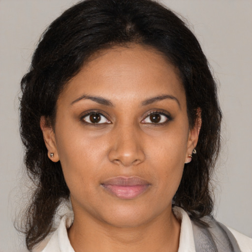 Neutral latino young-adult female with medium  brown hair and brown eyes