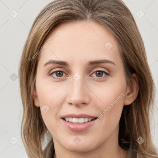 Joyful white young-adult female with long  brown hair and grey eyes