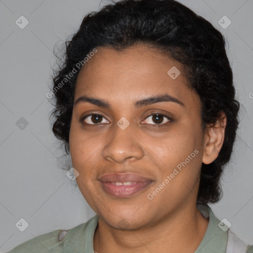 Joyful black young-adult female with medium  black hair and brown eyes